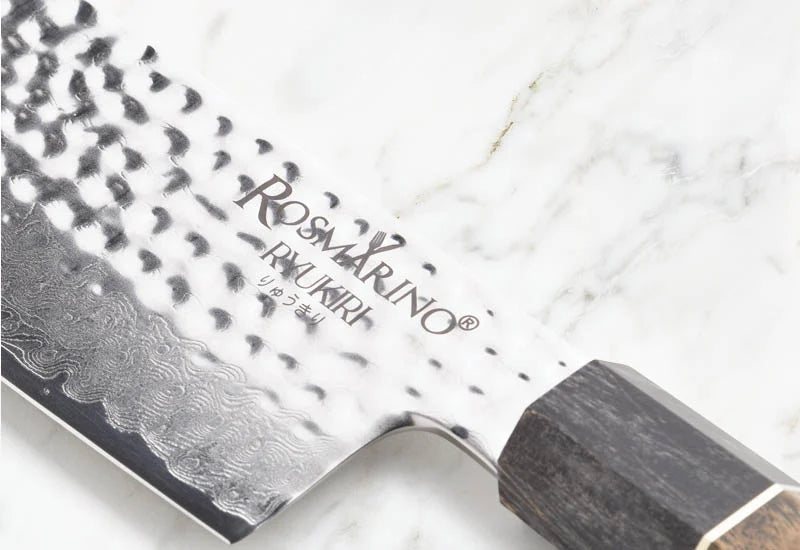 A combination of premium stainless steel, Damascus pattern, and a wooden handle.